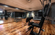 © Kavi Sanchez/ADDICTIVE STOCK - Interior of modern sports center with training machines and mirror along wall