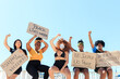 © Picua Estudio/ADDICTIVE STOCK - Group of multiethnic female activists protesting with raised arms in city with carton placards with black lives matter inscription and looking at camera