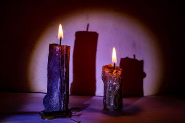 Two burning candles in the dusk of a vintage night room