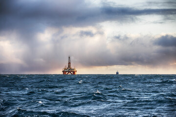 Wall Mural - Offshore oil rig at sunset time