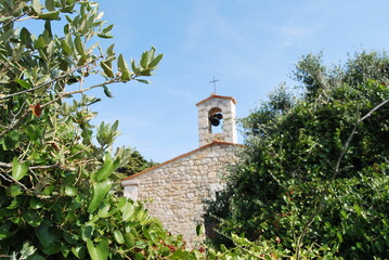 
small stone chapel with bell on the roof