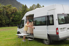 Man With Campervan On Campground