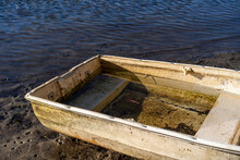 Abandoned Old Steel Dingy Boat, Washed Up On Shoreline.
