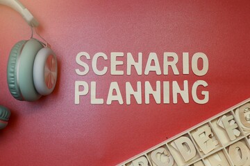 Text on scenario planning from block letters and headphone on a red background 