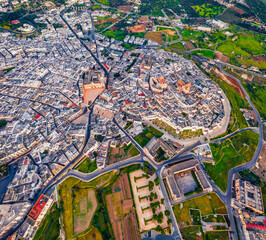 Wall Mural - View from flying drone. Breathtaking spring cityscape of Ostuni town. Aerial morning view of Apulia, Italy, Europe. Traveling concept background.