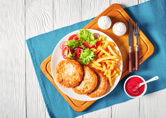 Wall Mural - turkey burgers served with salad and fries