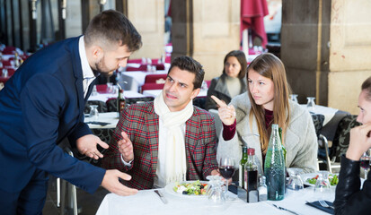 Wall Mural - Angry guests complaining to manager about food and service in restaurant