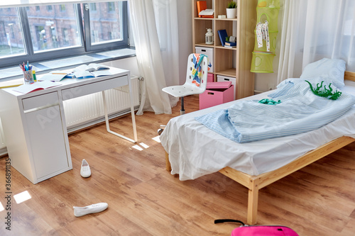 mess, disorder and interior concept - view of messy home kid\'s room with scattered stuff