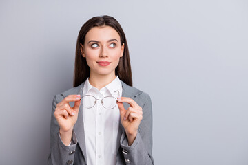 Photo of attractive business lady taking off specs good eyesight after laser correction operation look empty space dreamer wear white shirt plaid blazer isolated grey color background