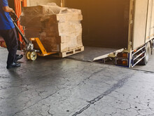 Worker Driving Forklift Loading And Unloading Shipment Carton Boxes And Goods On Wooden Pallet From Container Truck To Warehouse Cargo Storage In Logistics And Transportation Industrial 