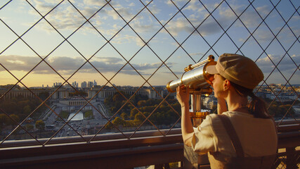 Wall Mural - Young tourist looking through binoculars at the view point