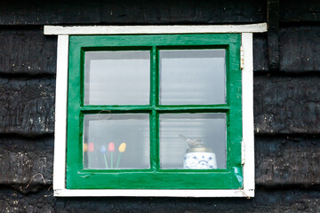 Wall Mural - Old fashioned traditional wood window and wooden black wall in Amsterdam, The Netherlands