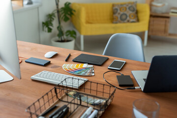 Wall Mural - Graphic designers workplace with color swatch, digitizer, smartphone and computers in home office