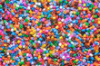 © Leka - multi-colored plastic beads, small pieces of plastic mosaic, background for children's creativity, the development of fine motor skills