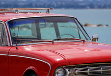 Vintage Red Car Parked By The Beach. Silver Beach, Sydney. 