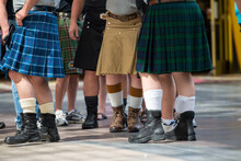 St. John's, NL/Canada - A Group Of Men Wearing Kilts On A Street. Some Have Boots On And Others Sneakers. The Kilts Are Both Green,blue,tan And Have A Pattern On Them.The View Is From The Waist Down.