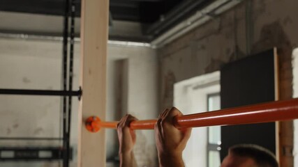 Wall Mural - sport, fitness, exercising and people concept - man doing pull-ups on horizontal bar in gym