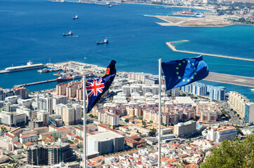 State ensign of Gibraltar and flag of European Union. Gibraltar city on the background.