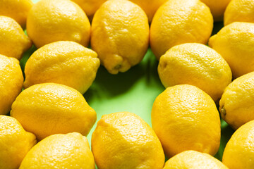 fresh ripe yellow lemons on green background