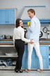 © Svyatoslav Lypynskyy - Pretty woman grabbing her mans butt. Beautiful lady flirting with husband by grabbing his butt while both of them are standing in front of kitchen table cooking.