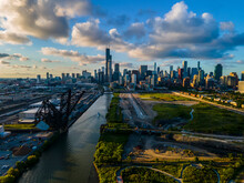 Aerial Drone Shot Of Chicago Beautiful Metropolis Skyline During Sunset Along The River.  The Cloud Are Vibrant With Color As The City Architecture It Cinematic 