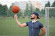 © Vladimir - Man on a street Playground turns a basketball on his finger