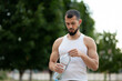 © Vladimir - Sporty young man drinking water in park