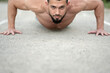 © Vladimir - A young athlete does push-UPS. Sports, fitness, street workout concept