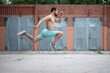 © Vladimir - Athlete runs fast in the street yard