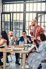 business, food, lunch and people concept - happy international business team eating pizza in office. Outsider on the office team