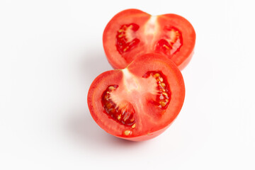 Sliced ripe tomato on a white background.