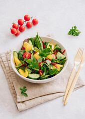 Wall Mural - Vegetable salad with olive oil in white bowl on linen napkin