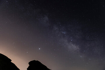 Wall Mural - the milky way over the canyon in the desert