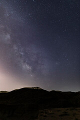 Wall Mural - the milky way over the canyon in the desert