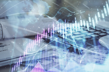 Double exposure of financial chart drawings and desk with open notebook background. Concept of forex market