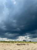 Fototapeta  - Ominous clouds roll in over Salisbury beach in Massachusetts on a stormy summer July day