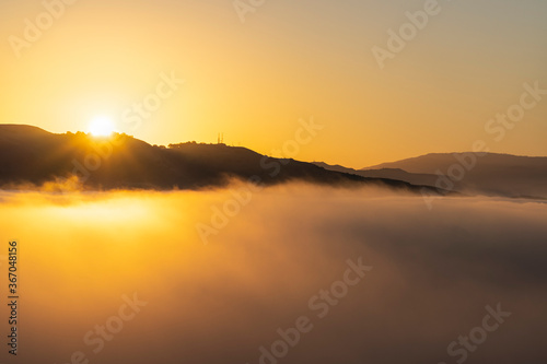 Sunrise cloud top view towa...