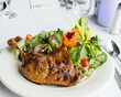 Roasted cuy (guinea pig) with green salad in Peru.