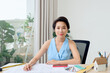 © makistock - Portrait of young Asian architect sitting in her office