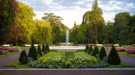 Flower arrangements in symetrical shapes leading up to a fountain in the city park Stadsparken in the town Lund, Sweden