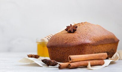 Poster - Spicy honey cake with cinnamon and anise star on light grey concrete background. Honey cake for Rosh Hashanah.