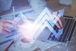© peshkova - Growing arrows with businessman working on computer on background. Success concept. Double exposure.