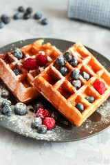 Wall Mural - Homemade belgian waffles with berries for breakfast. Closeup view