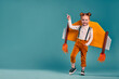 Beautiful little child girl with homemade cardboard plane wings, imagination and girl power concept