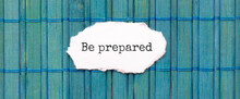 BE PREPARED Text On The Piece Of Paper On The Green Wood Background