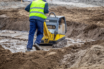 Wall Mural - Vibrating machine compacting soil