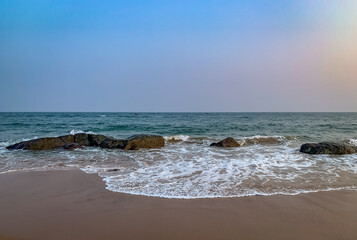 wide view of sea sore with waves and  cloudy sky in the evening 