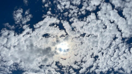 blue sky with clouds over the sun