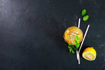 Wall Mural - Lemon ice tea on dark background with mint and ice. Photo with copy space