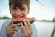 young little minor boy, eating slice of watermelon